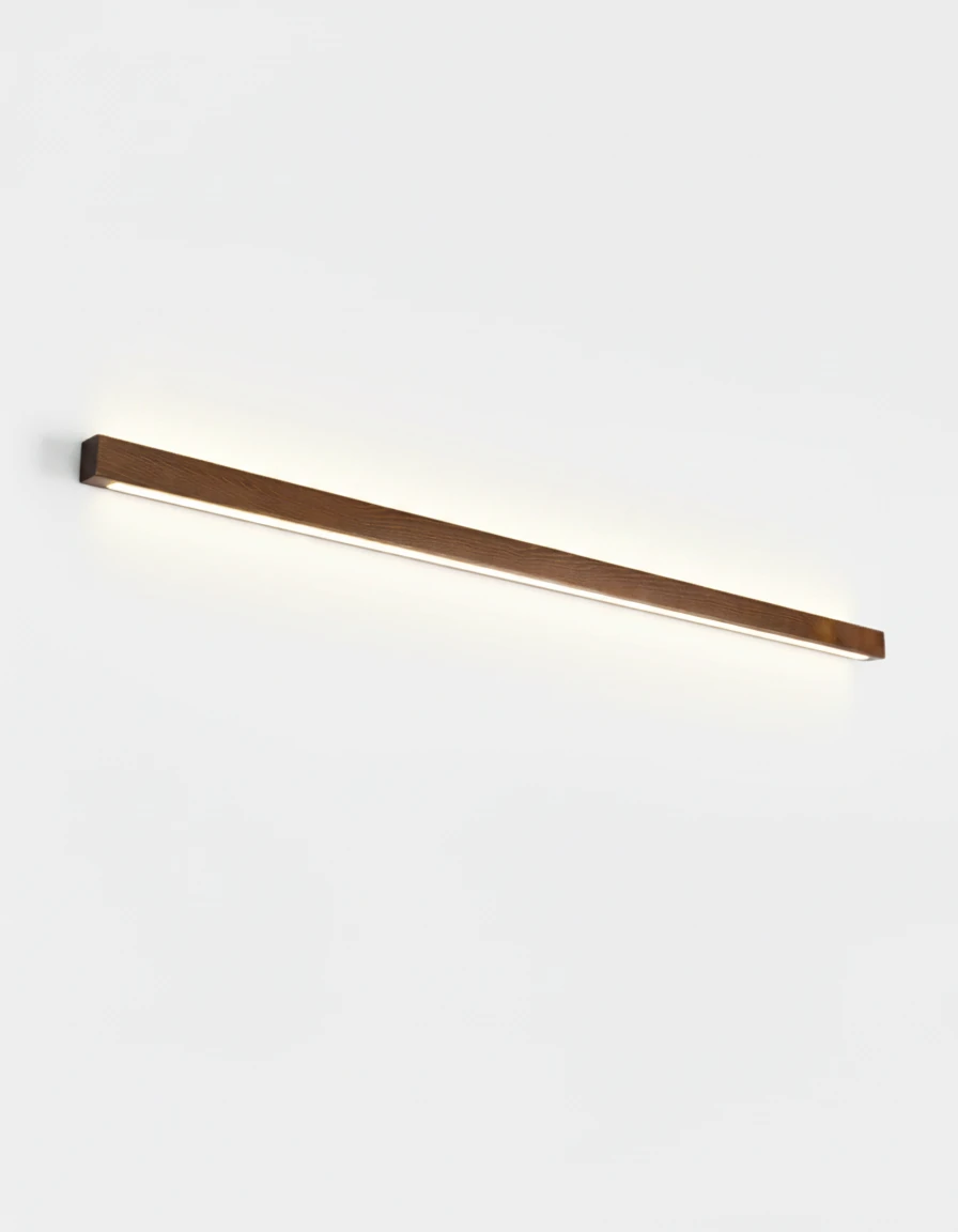 Wood wall sconce PIANO No.01 in dark walnut, 100 cm up-and-down LED bar switched on