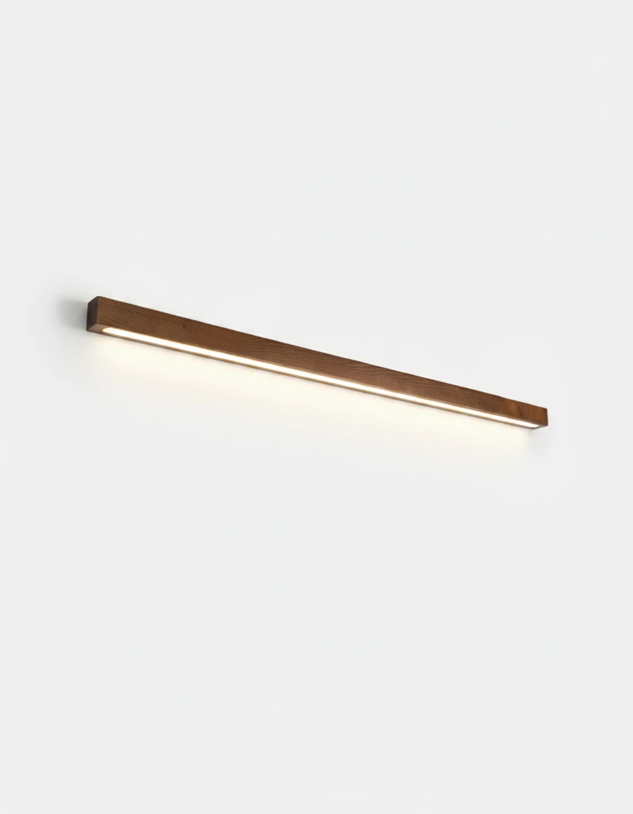 Wood wall sconce PIANO No.01 in dark walnut, 80 cm bar throwing light downward onto a white wall, lit