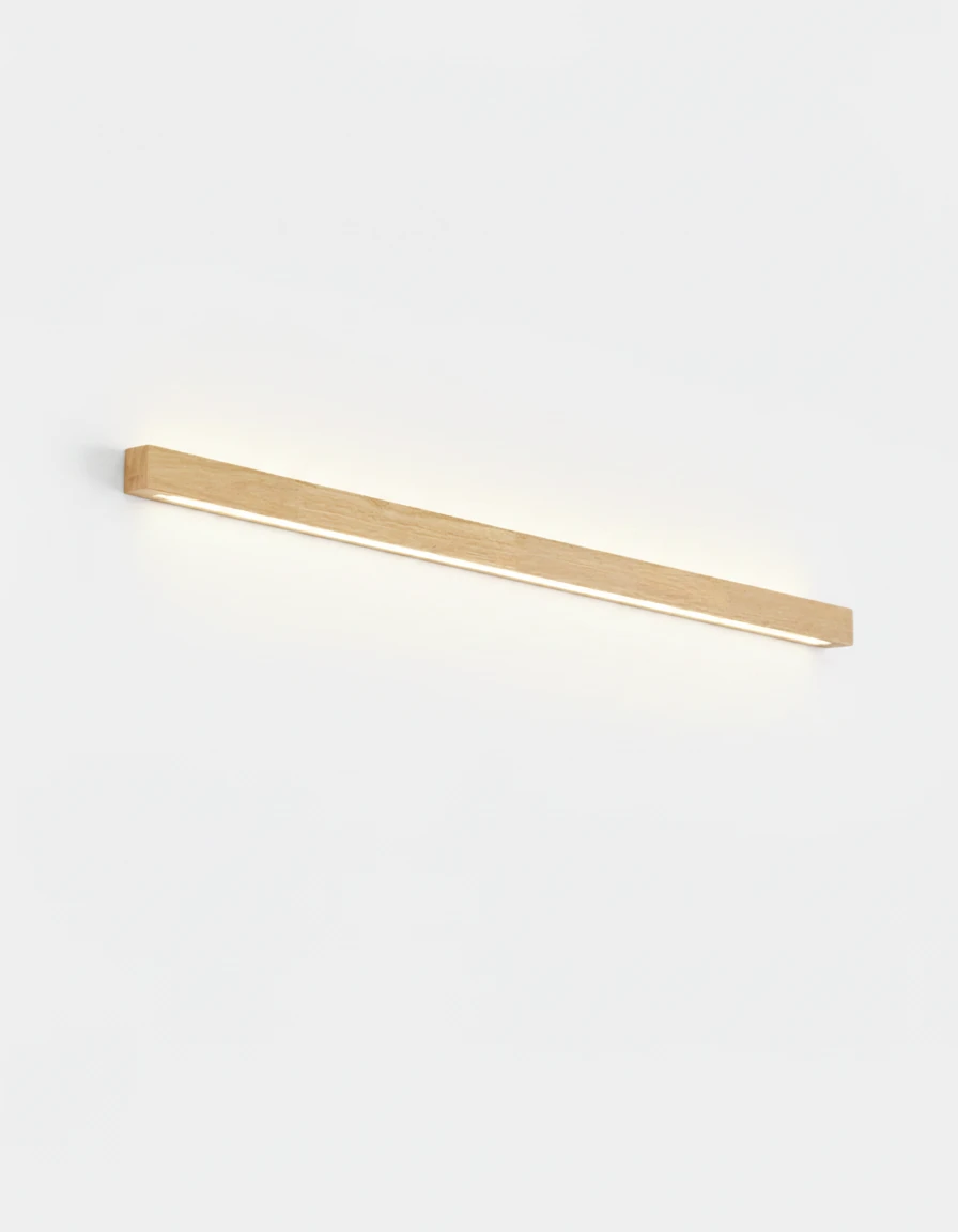 Wood wall sconce PIANO No.01, 80 cm light walnut bar lit above and below on a white wall