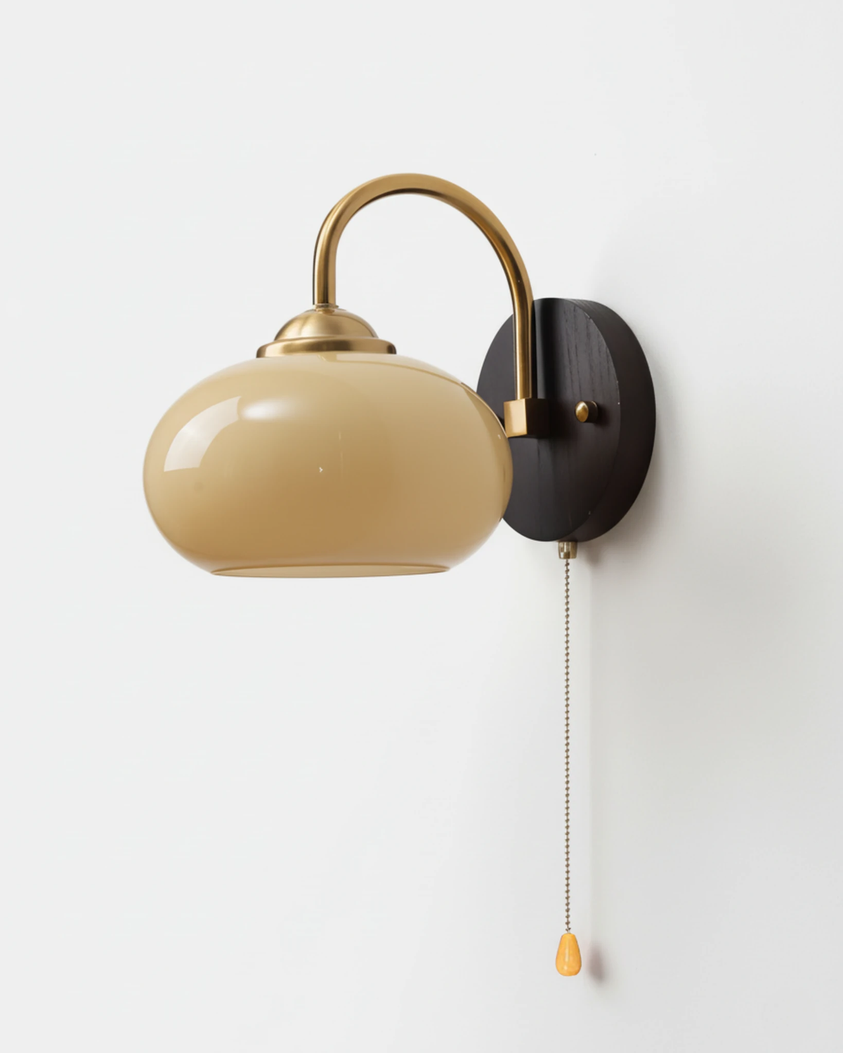 Wood wall sconce CURVA No.02 in Soft Beige, pale glass shade on a curved brass arm, walnut backplate and pull chain