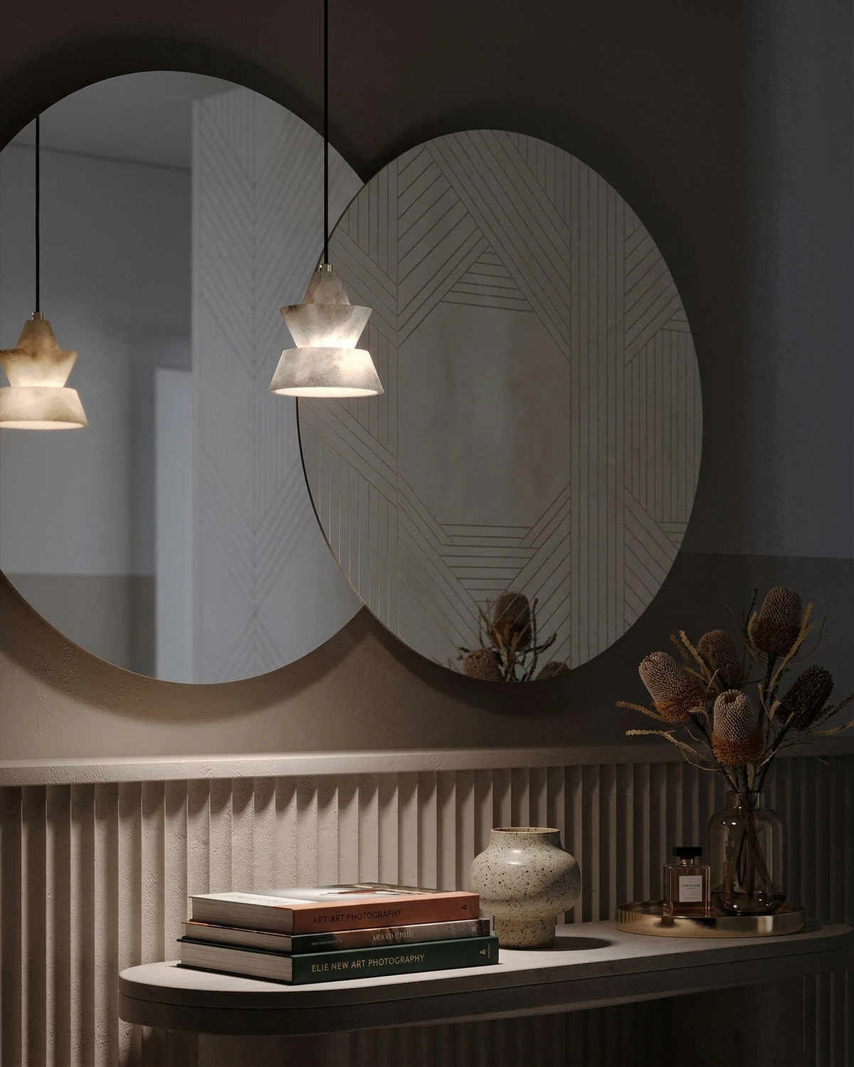 Alabaster pendant light ALABA No.06 lit in front of two overlapping round mirrors above a console with books