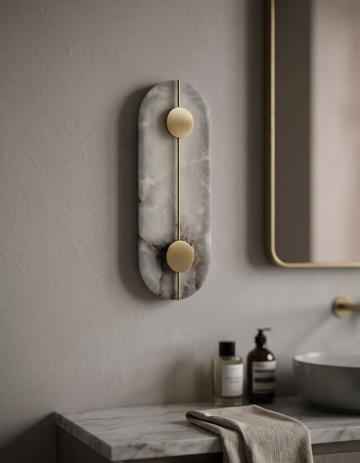 Alabaster wall sconce OLIVA No.03 Oval with brass inlay lit beside a mirror above a bathroom sink