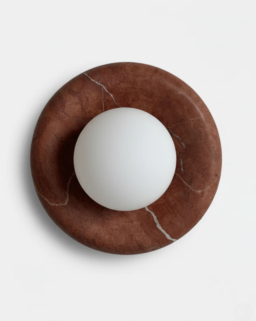 Alabaster wall sconce LATTE No.02 in Coral Red, terracotta red stone ring holding a frosted glass sphere, unlit