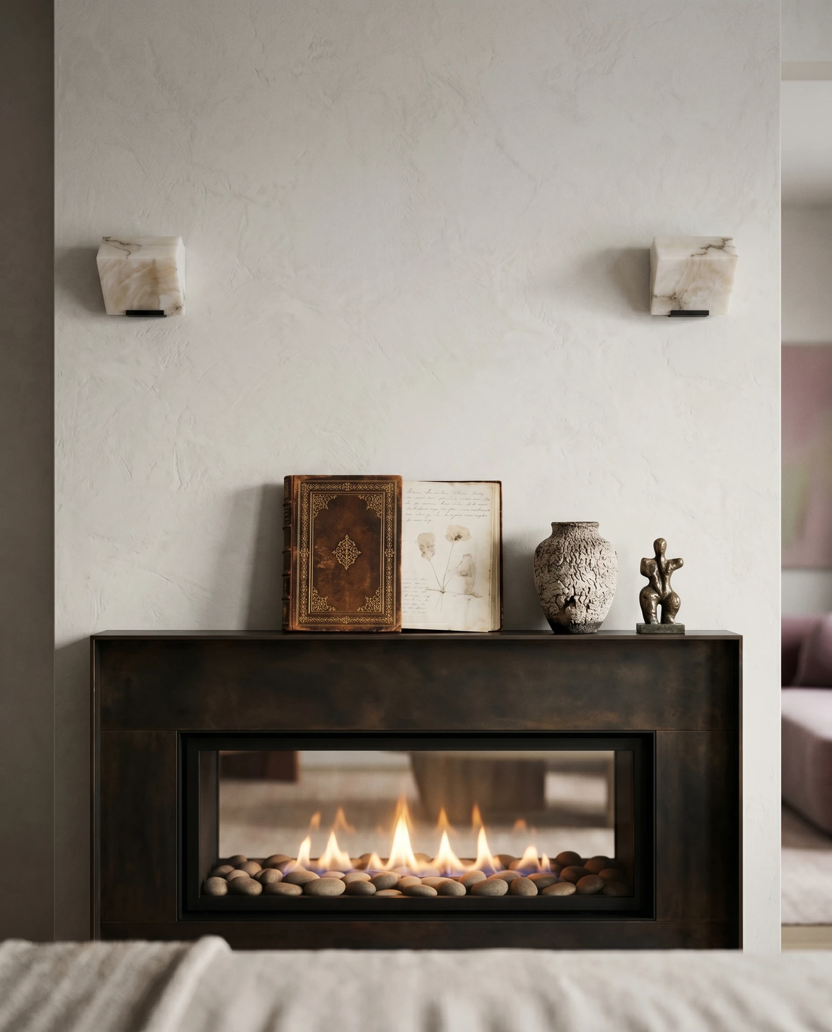 Two alabaster wall sconces ALABA No.05 solo, unlit, flanking a fireplace and mantel with framed prints