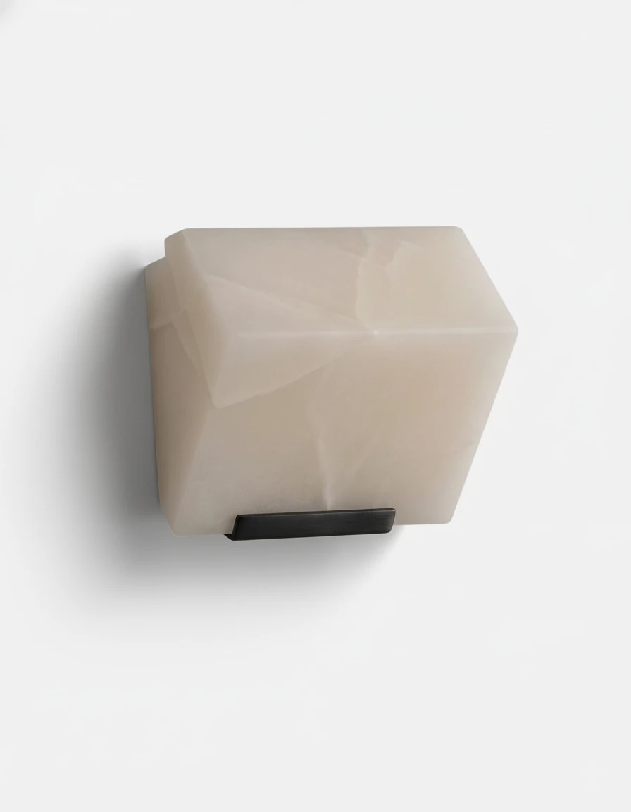 Alabaster wall sconce ALABA No.05 solo, one faceted alabaster block on a black bracket, unlit on white