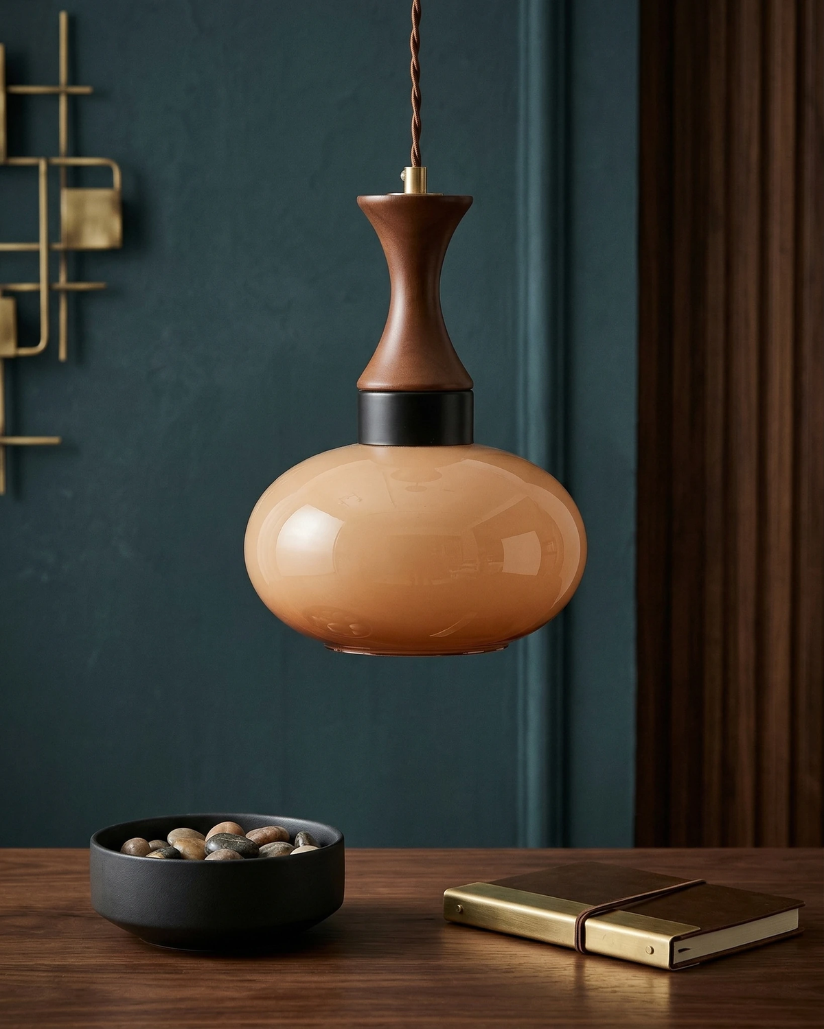 Amber glass pendant light OVIA No.04, dome shade above a walnut table against a dark teal wall