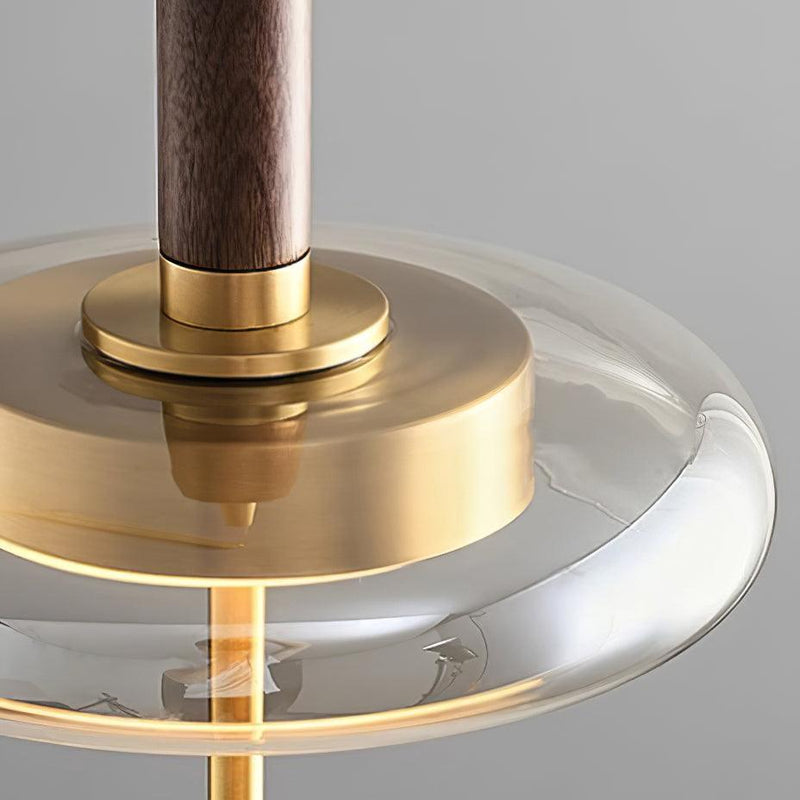 Close-up of the walnut stem, brass plate and amber glass disc of the NOCE No.01 amber glass pendant light