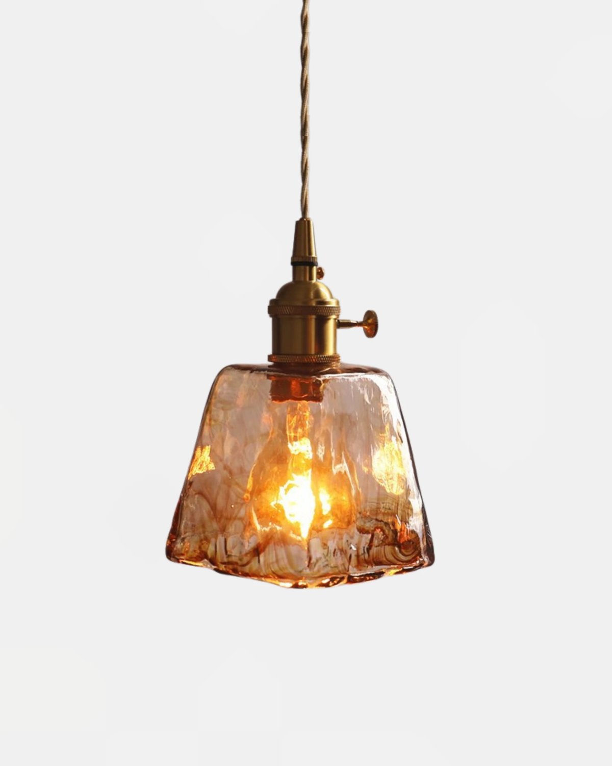 Amber glass pendant light OVIA No.05 in the Bell shape, flared marbled glass shade glowing with a brass socket above