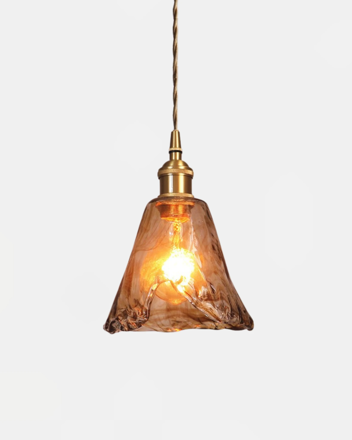 Amber glass pendant light OVIA No.05 in the Drop shape, tapered cone of marbled amber glass lit on a brass cord