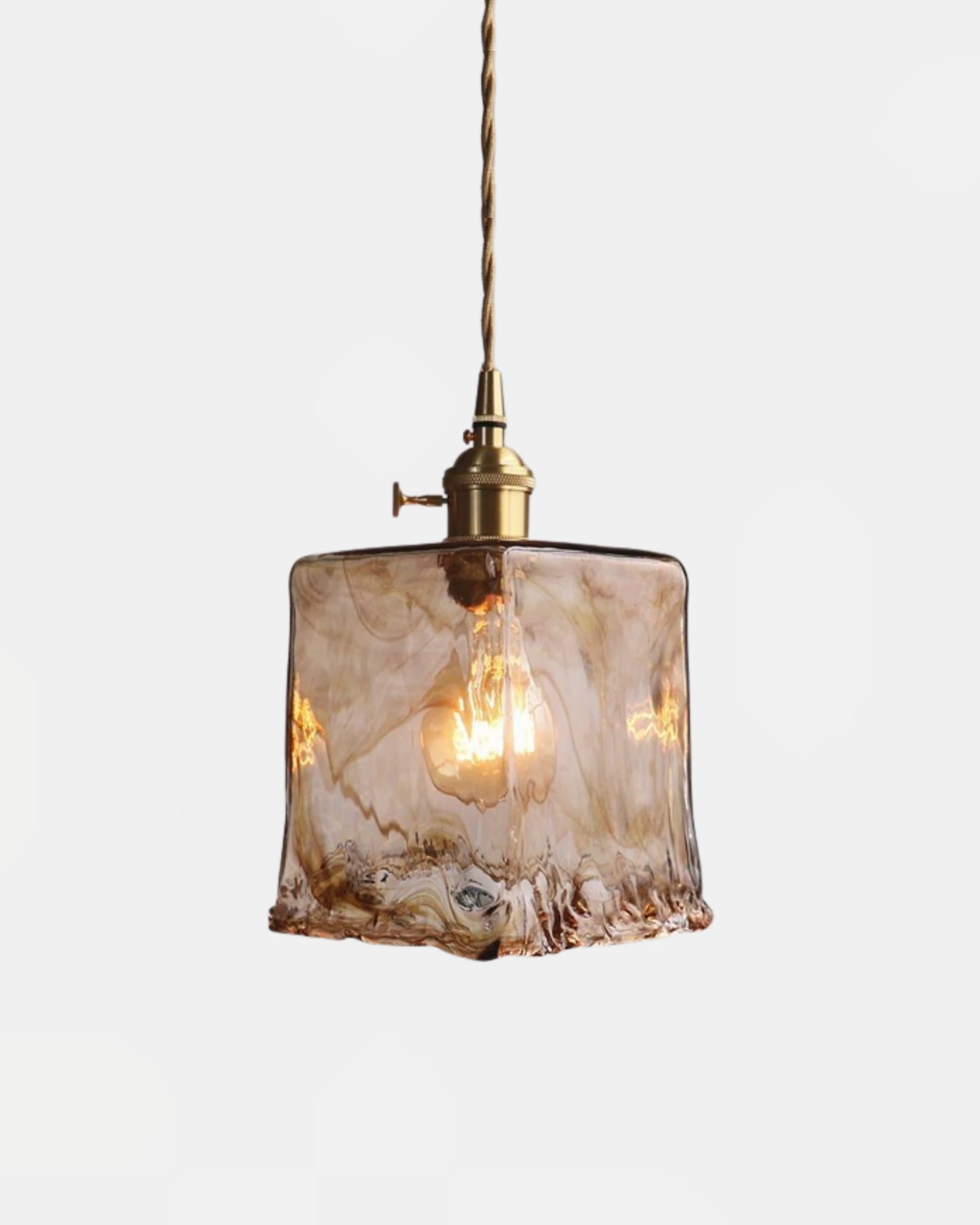 Amber glass pendant light OVIA No.05 in the Prism shape, square tapered glass shade switched on under a brass fitting