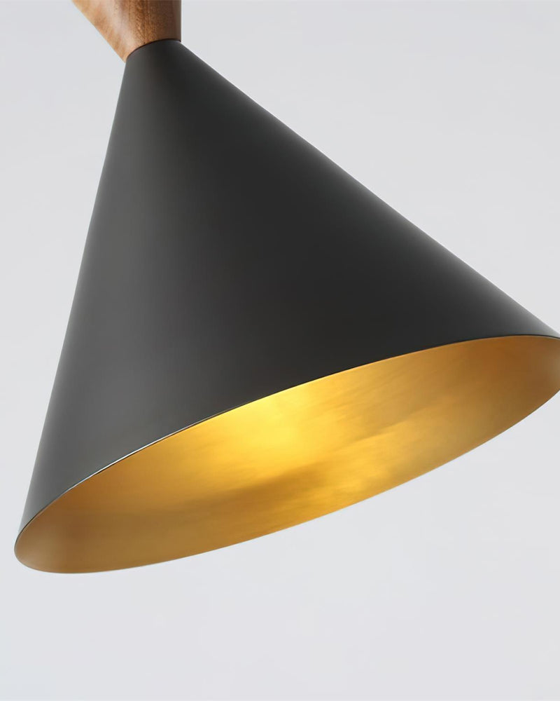 Close-up of the matte black cone and gold brass interior of the TARO No.01 brass pendant light