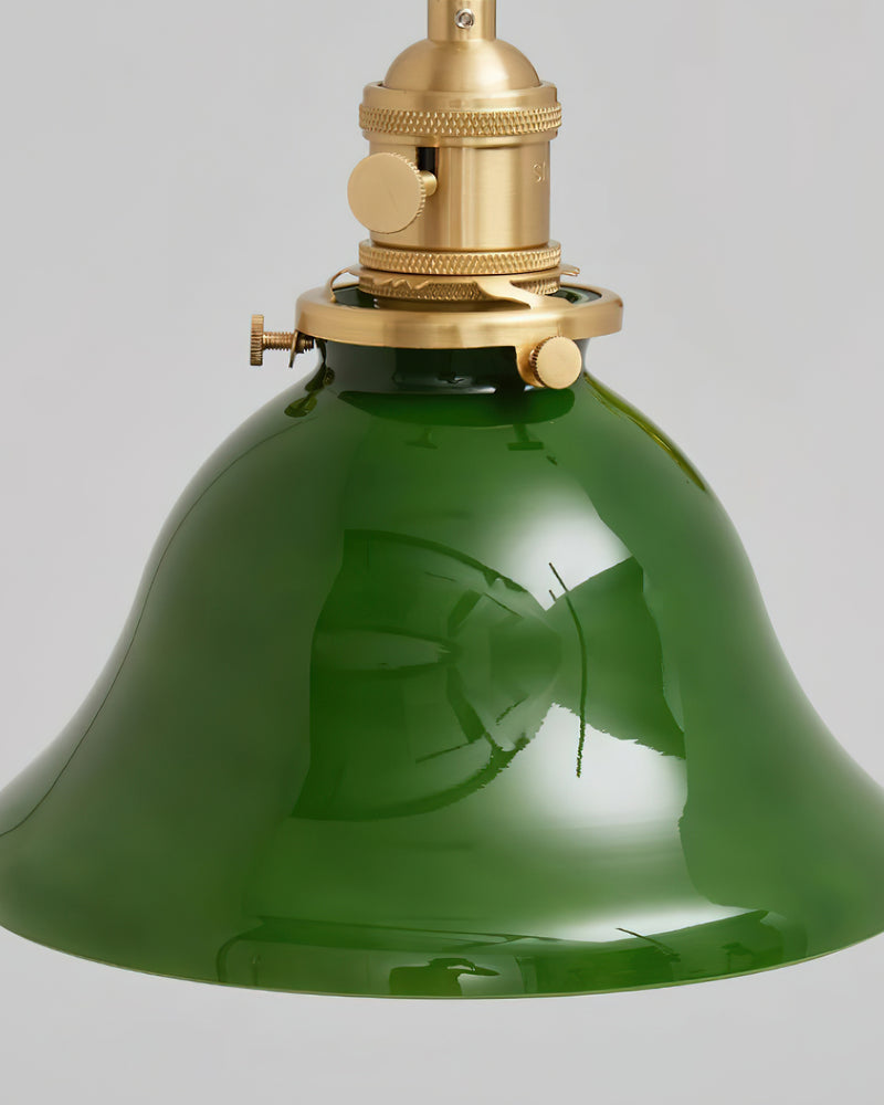 Close-up of the emerald green glass bell and brass socket of the DALIA No.04 brass wall sconce, seen from below