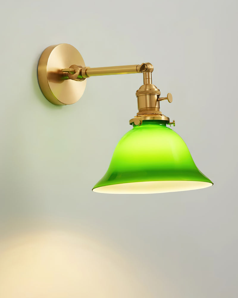 Brass wall sconce DALIA No.04 on a fixed arm, emerald glass bell glowing bright green when switched on