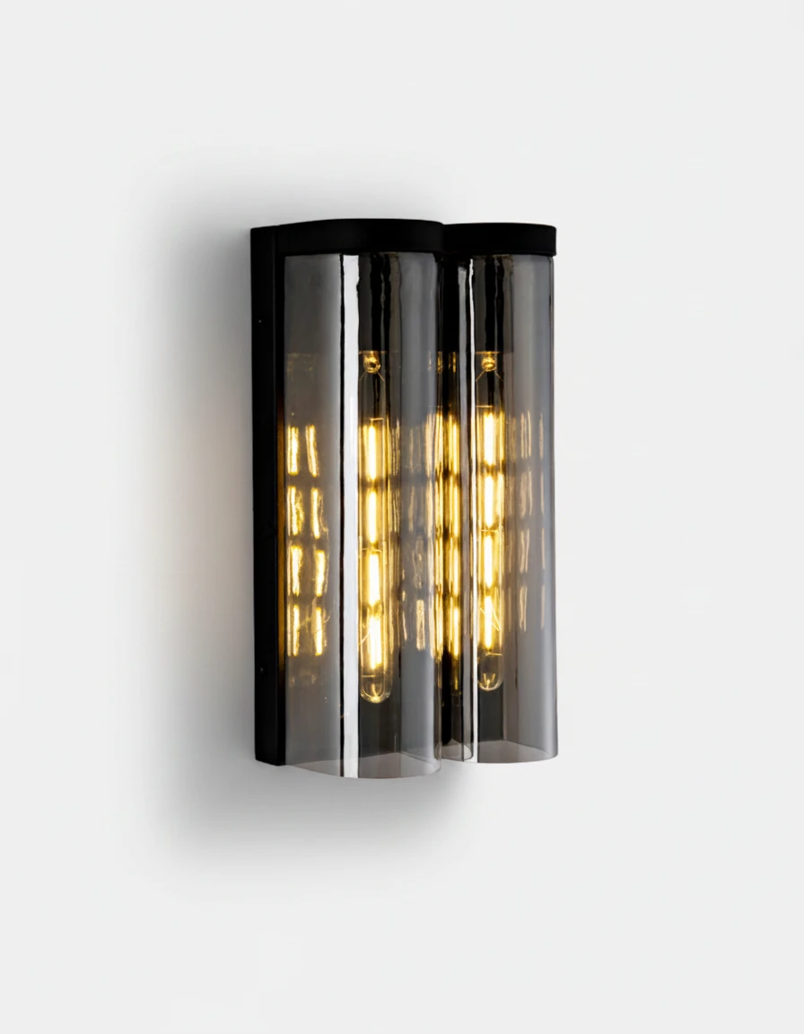 Brass wall sconce PILA No.01 Twin Shields, two smoked glass columns side by side on matte black iron, lit