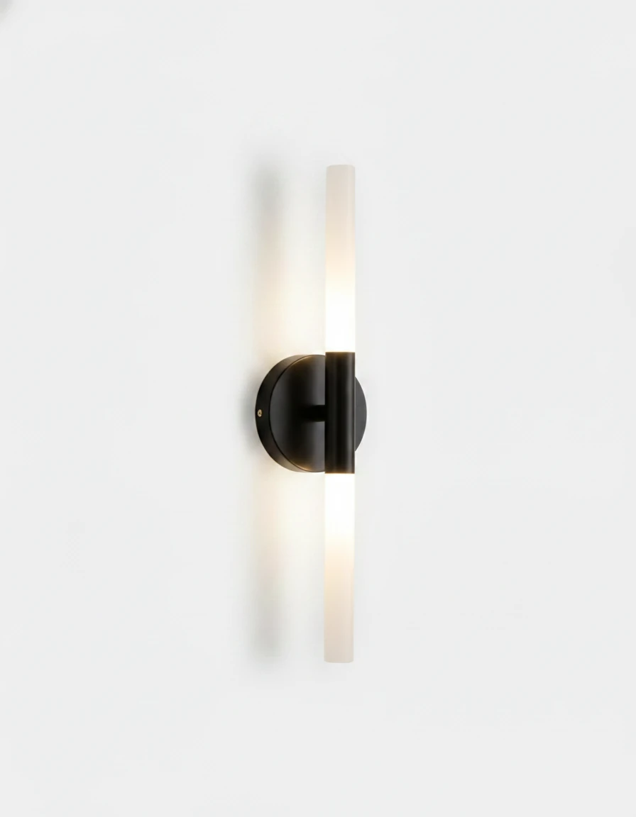 Brass wall sconce STELO No.01 in matte black, vertical frosted tube on a black half-round bracket, lit