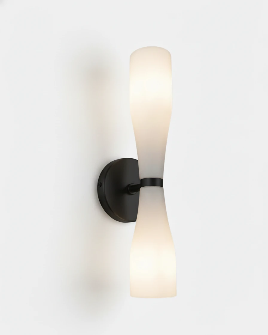 Brass wall sconce DALIA No.02 in Volcano Black, white hourglass glass switched on against a matte black backplate