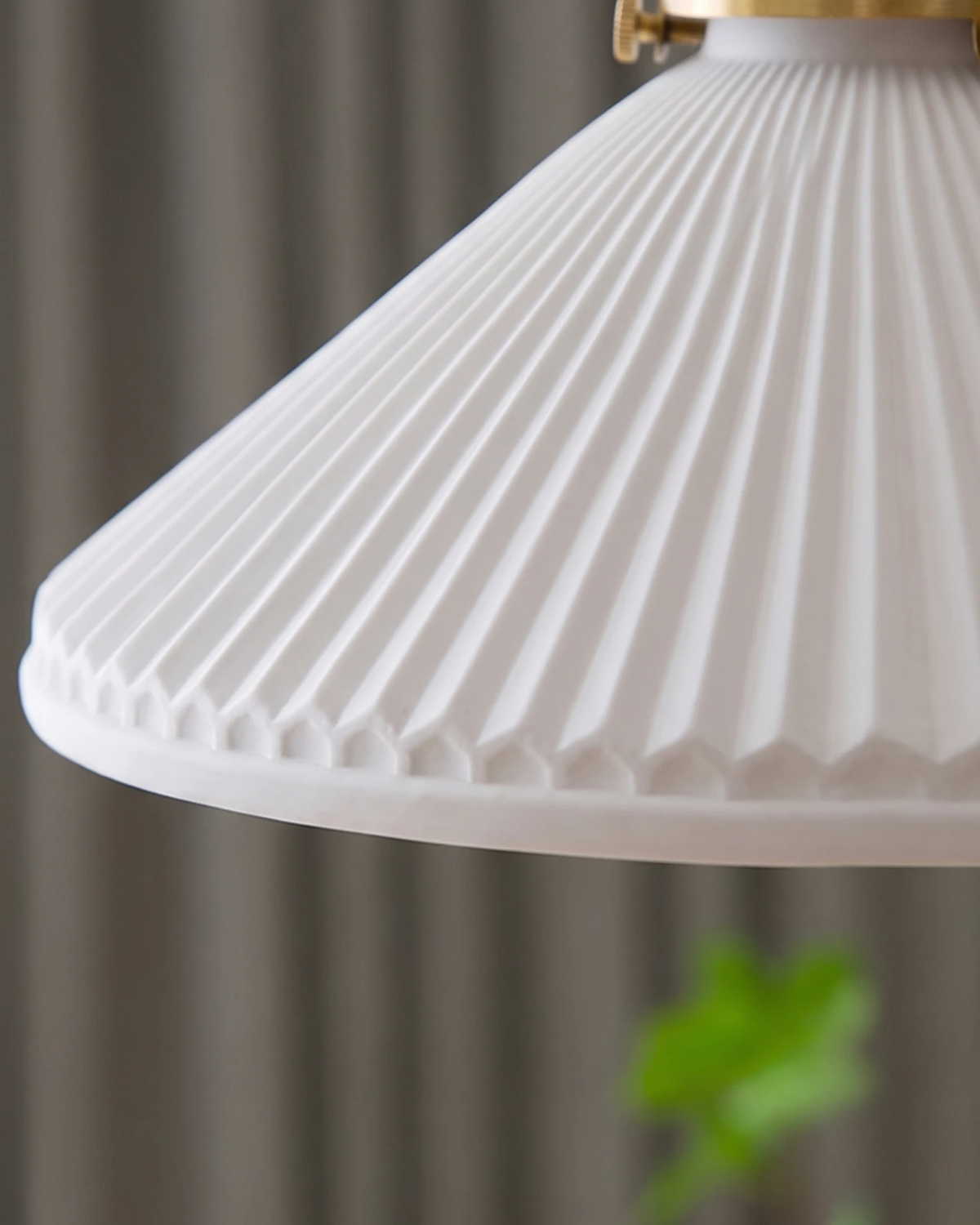 Close-up of the pleated cream porcelain shade of the CORA No.02 ceramic pendant light