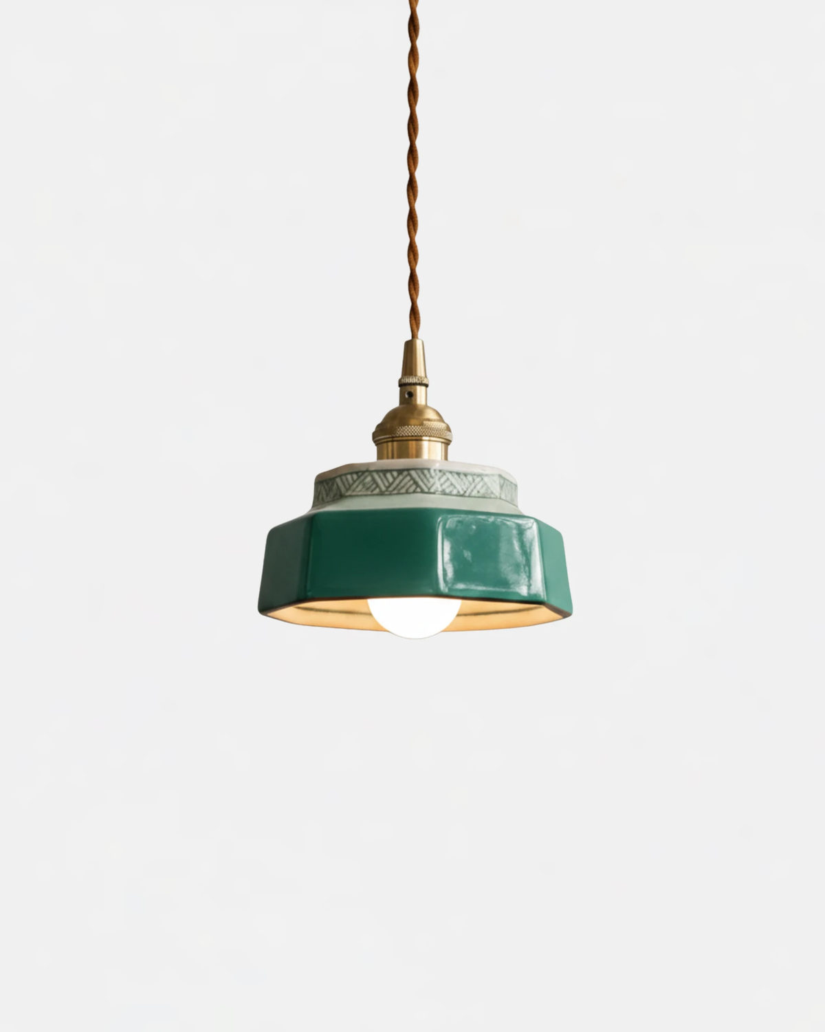 Ceramic pendant light RAGUSA No.01 in Forest Green, stacked shade with brass collar, switched on