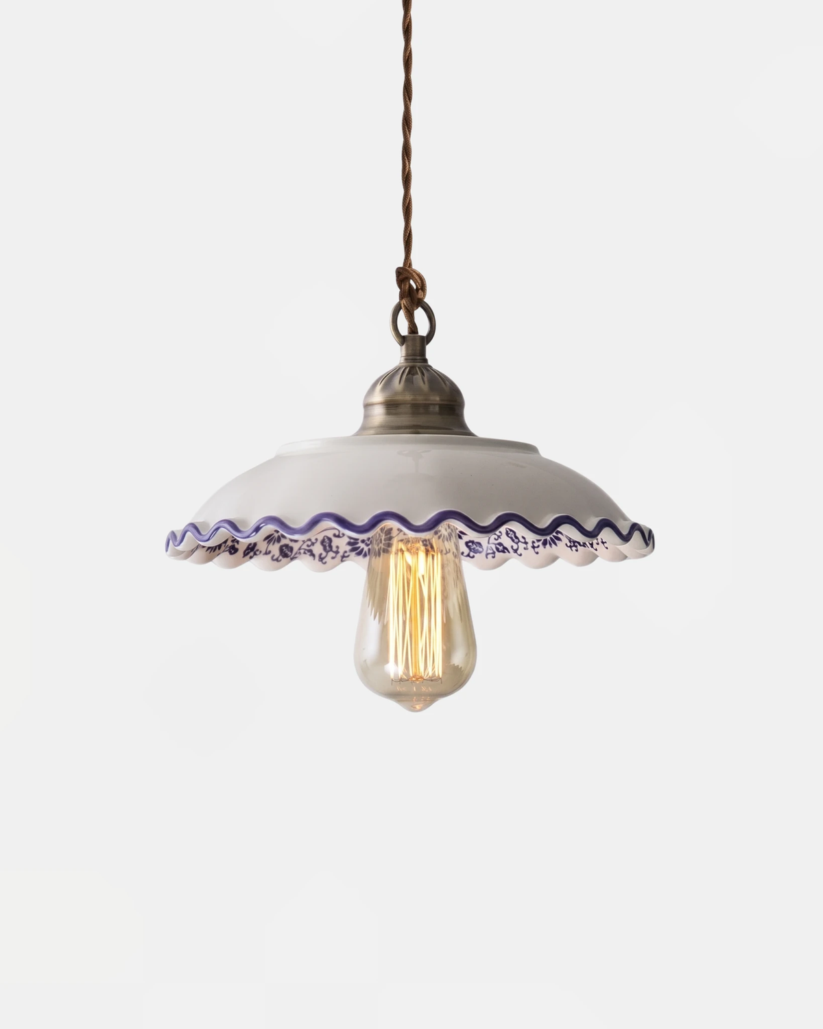 Ceramic pendant light MELI No.01 in the Ombrelle scalloped umbrella shape, blue trim and an exposed lit bulb