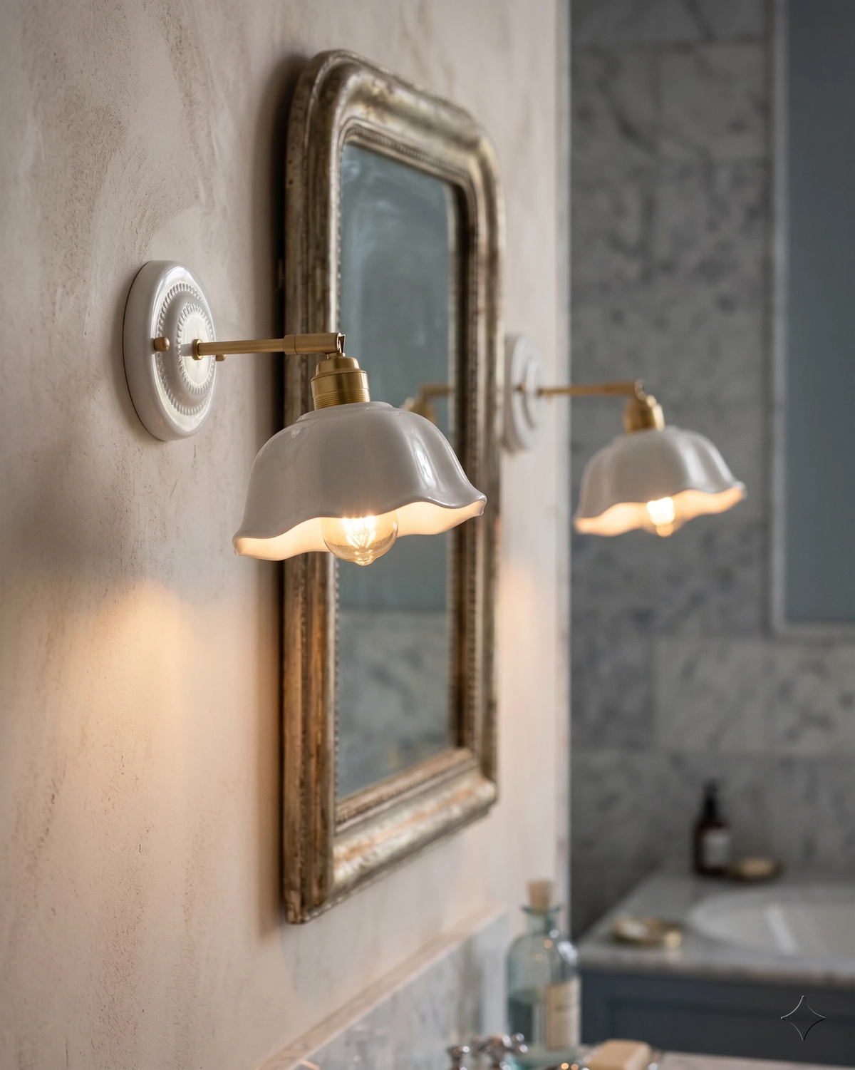 Ceramic wall sconce RIGA No.05, two scalloped shades lit beside an antique gilt mirror in a bathroom