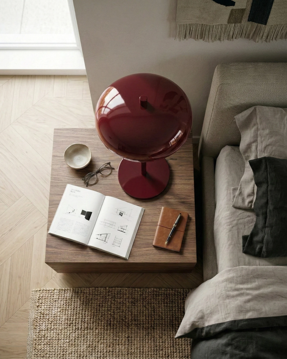 Cordless mushroom lamp DOMA No.01 in burgundy seen from above on a wooden nightstand with an open book and mug