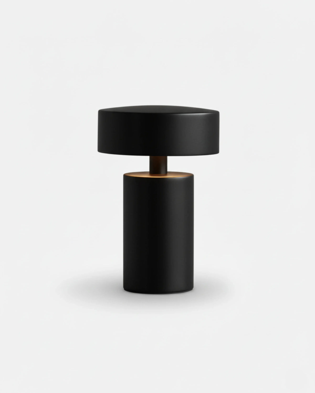 Cordless mushroom lamp PADOVA No.01 in Matte Black, black mushroom cap glowing underneath on a plain background