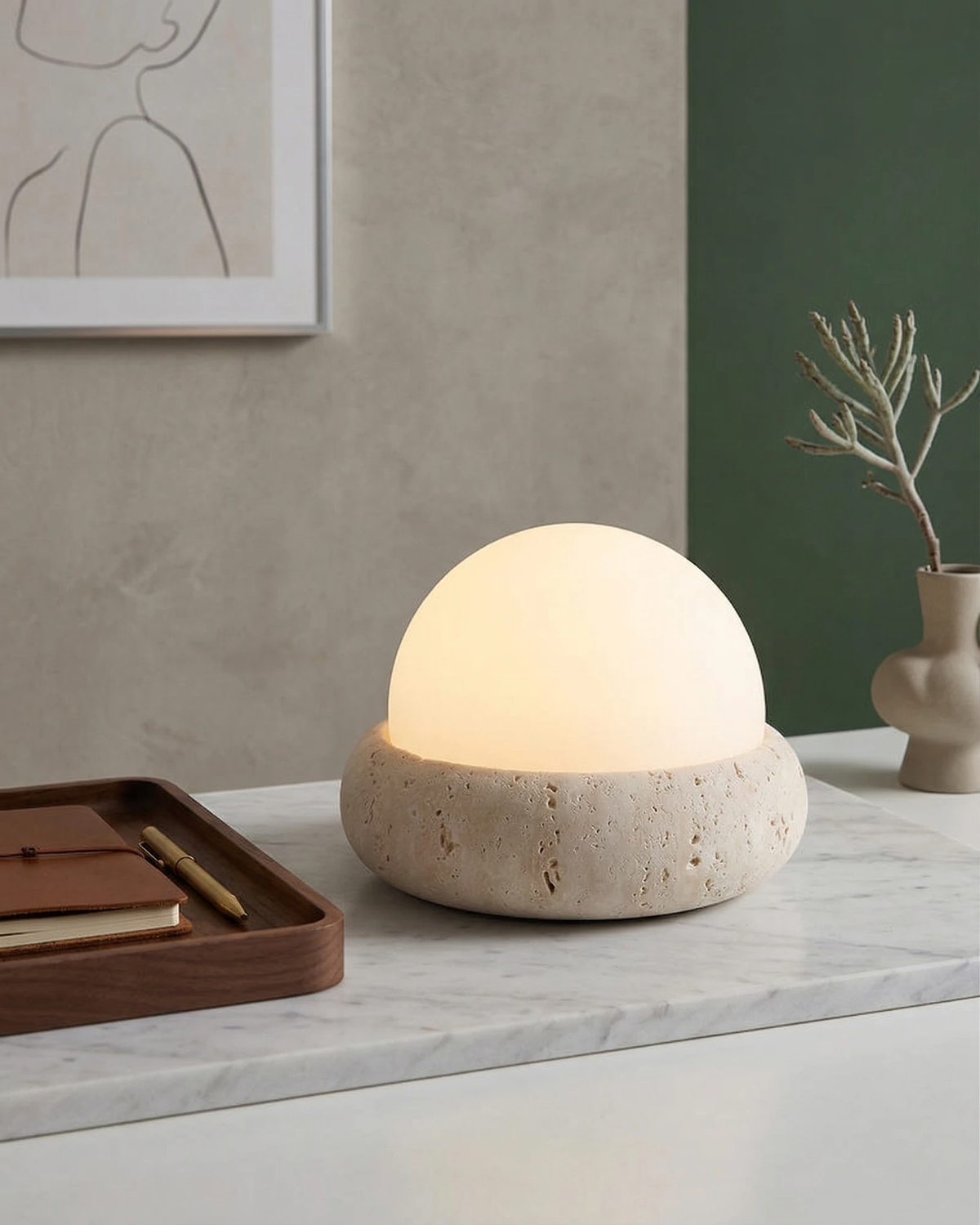 Cordless outdoor table lamp LUCE No.01 lit on a marble console beside a walnut tray with pens and a small vase