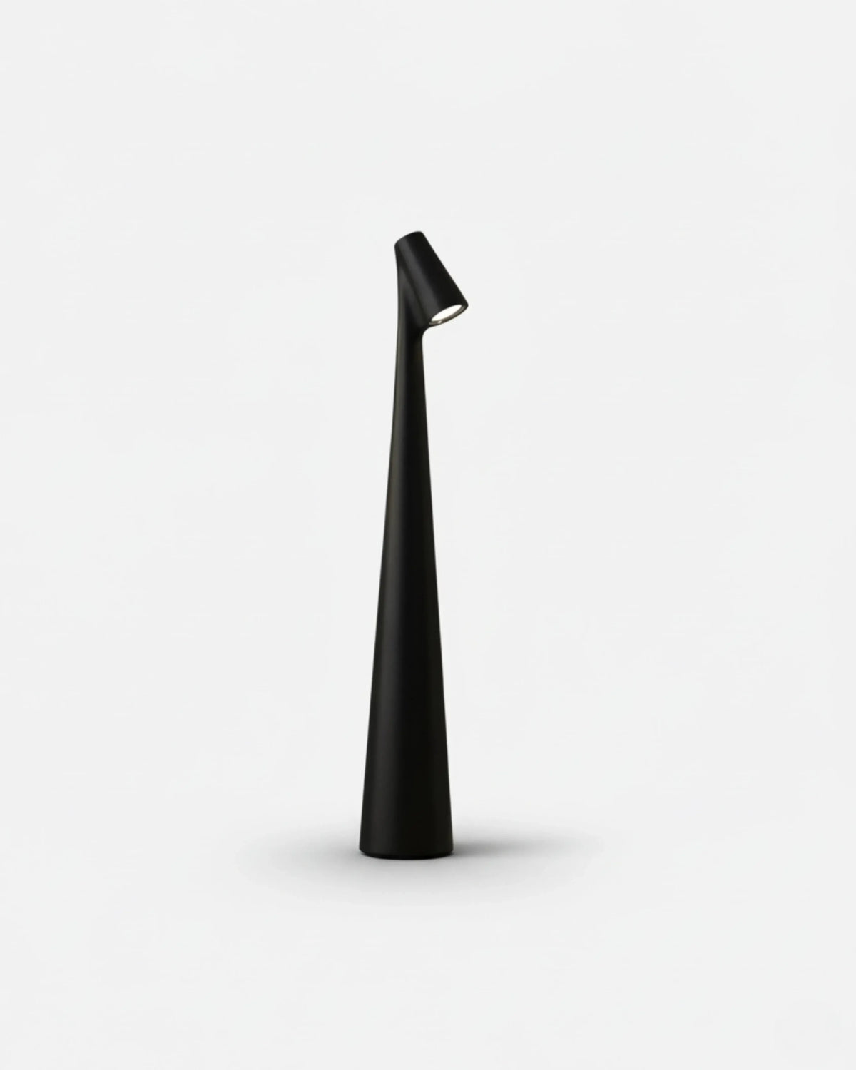 Cordless reading lamp TRIESTE No.01 in Black, slender tapered stem with an angled head on a white background