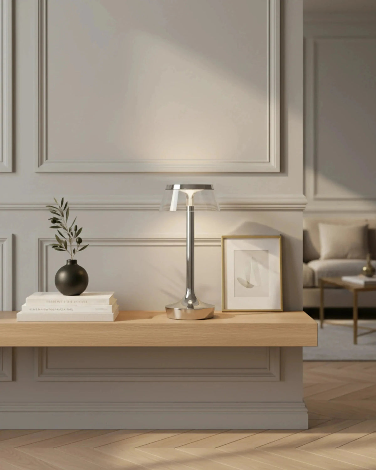 Cordless table lamp ZARA No.01 lit on a light oak console with books and a vase in a paneled room