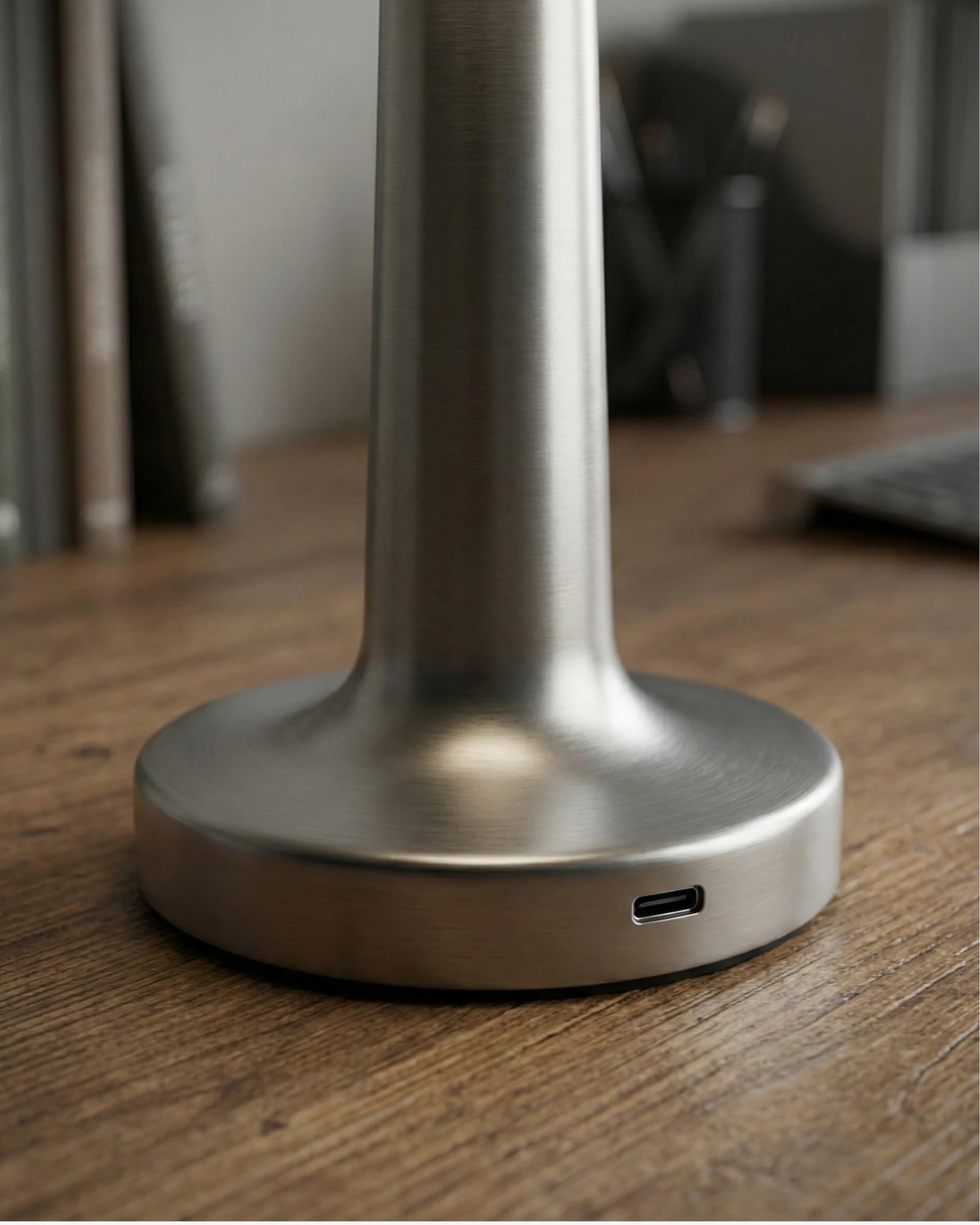 Close-up of the base of the ISOLA No.01 cordless table lamp in silver showing the USB-C charging port