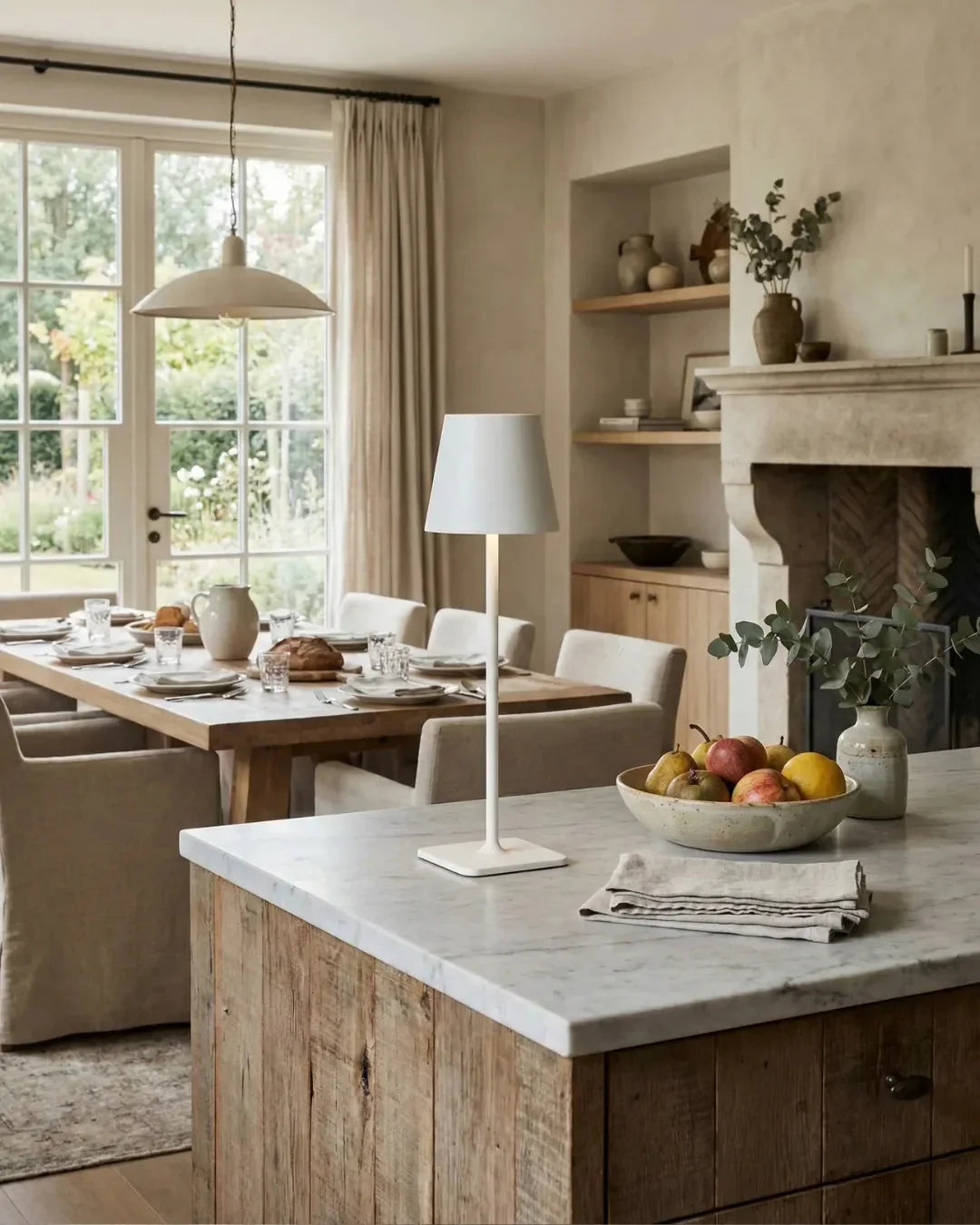 Cordless table lamp FOGGIA No.01 in white on a marble kitchen island laid with breakfast and a bowl of fruit