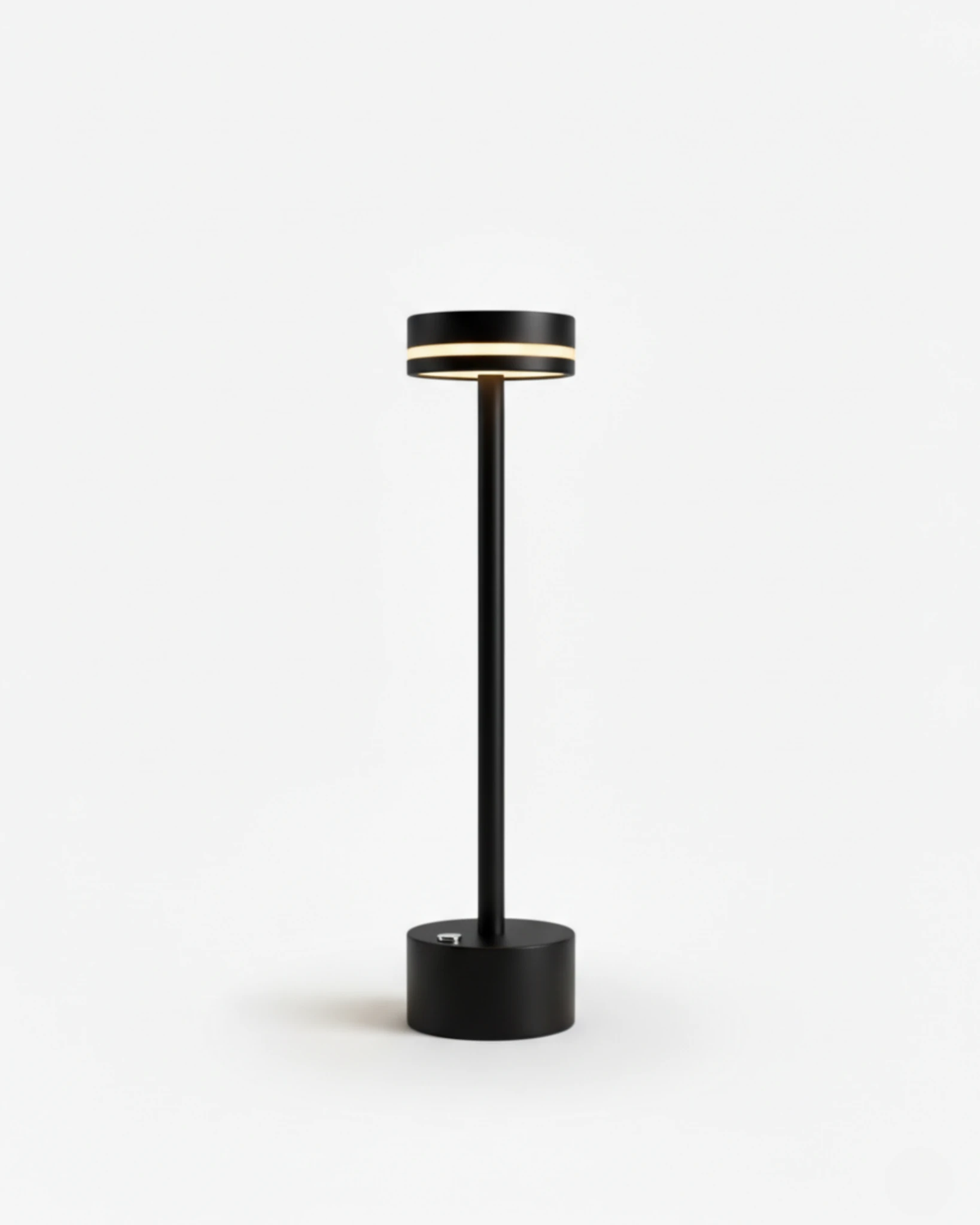 Cordless table lamp NIDO No.02 in Black, minimalist black stem and base with the LED ring switched on