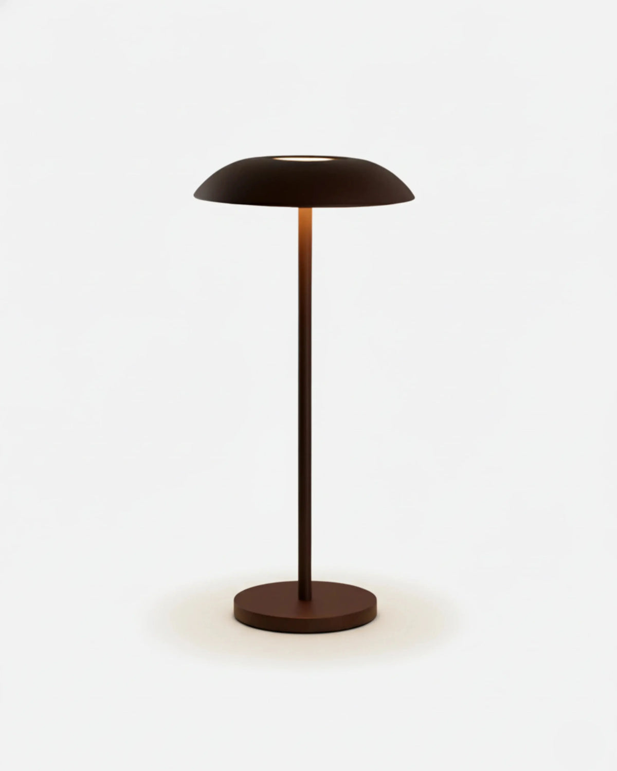 Cordless table lamp PESCARA No.01 in Brushed Brown, lit dome shade on a slender stem, plain background