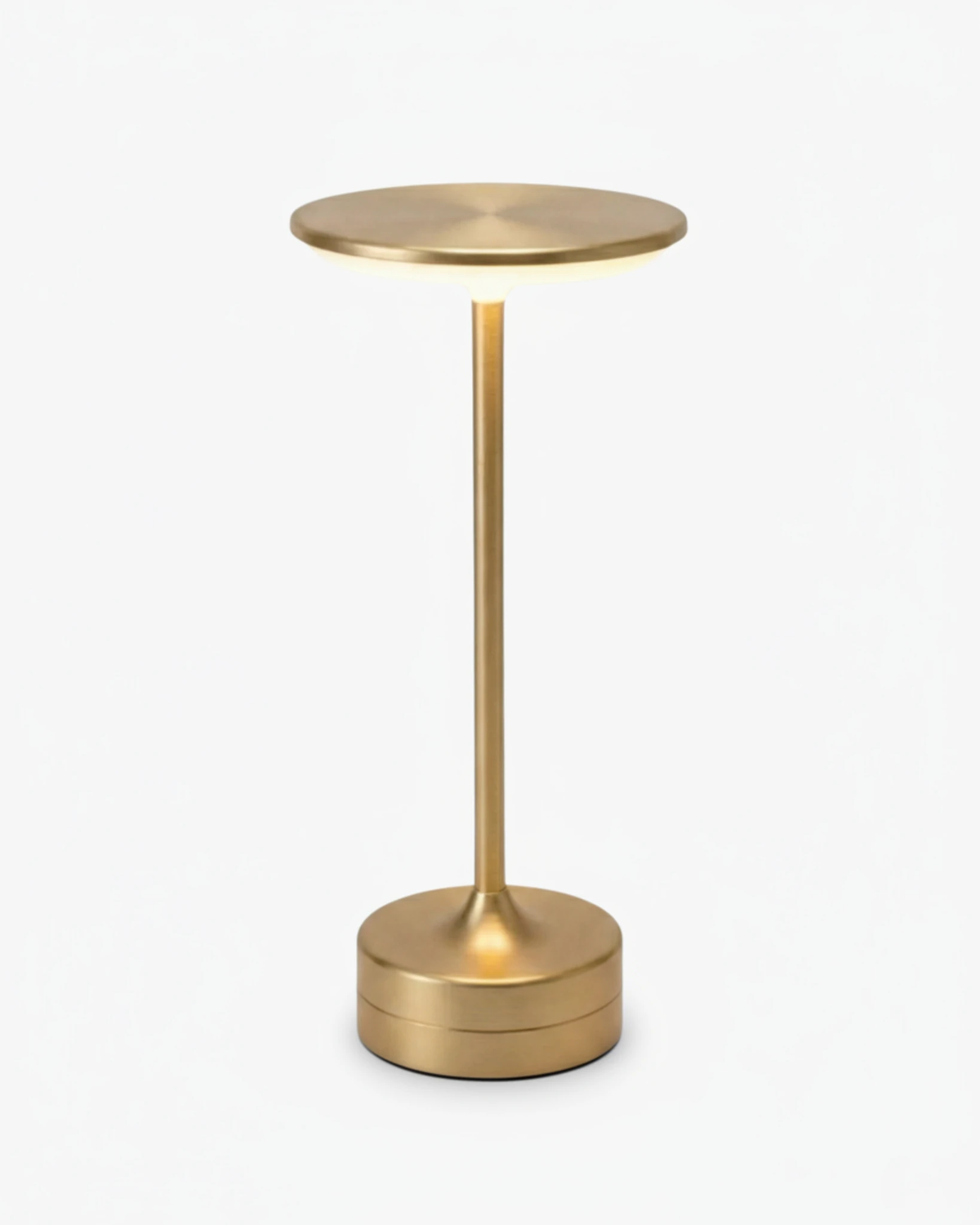 Cordless table lamp BRINDISI No.01 in Brushed Gold, disc top switched on above a slim stem and drum base