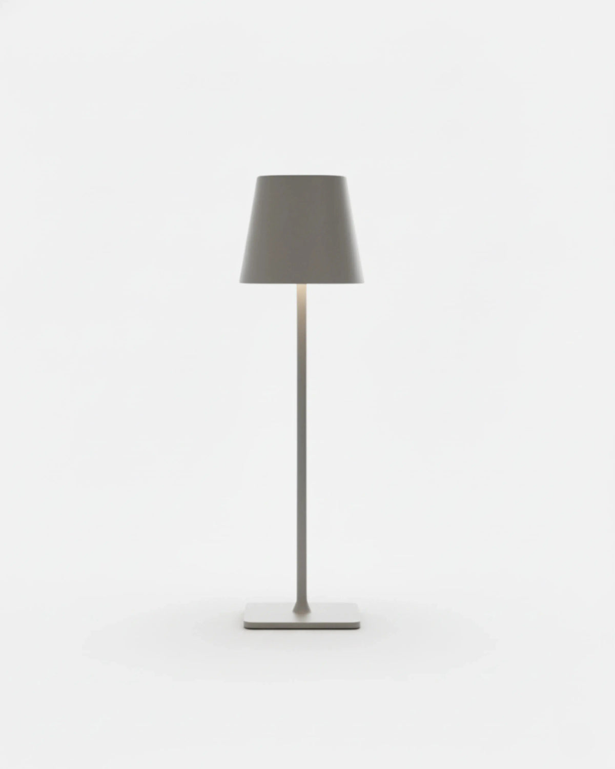 Cordless table lamp FOGGIA No.01 in Brushed Grey, warm gray cone shade lit over a thin stem and flat base