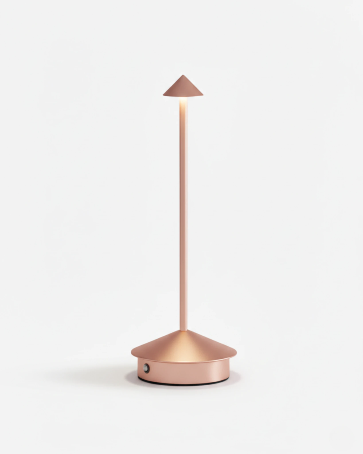 Cordless table lamp FERRARA No.01 in Brushed Rose Gold, cone head glowing on a slim stem, switched on