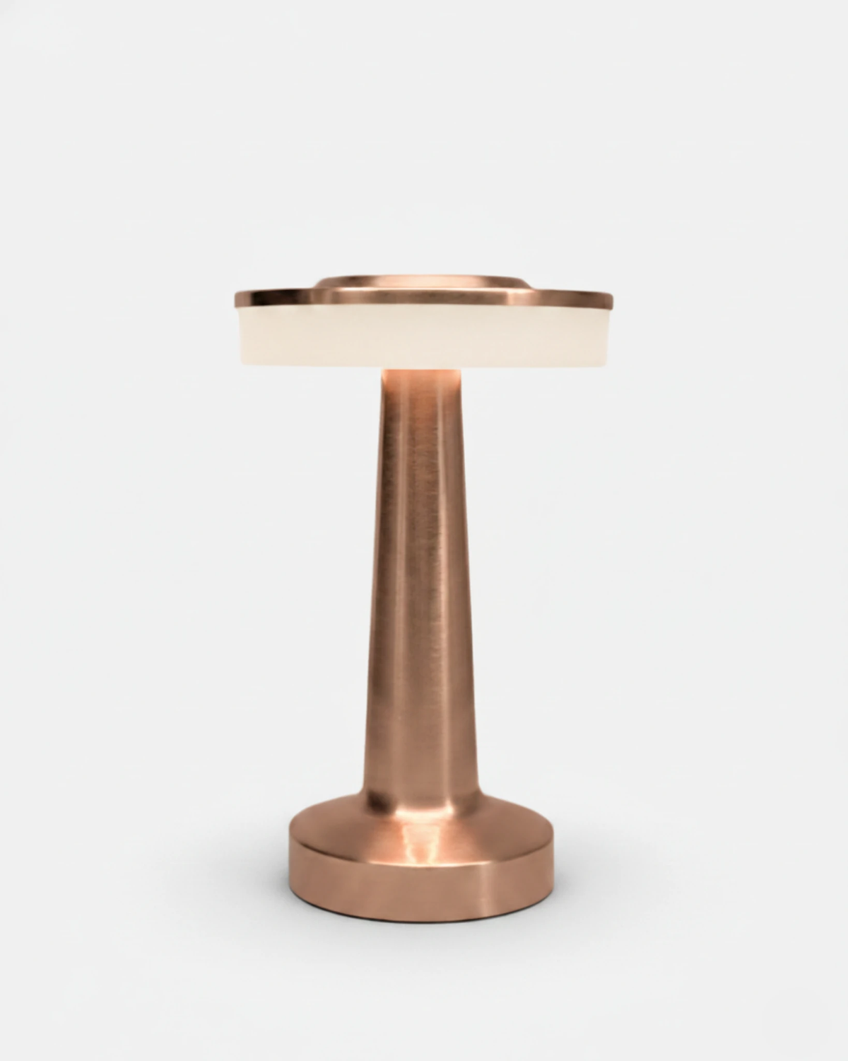 Cordless table lamp LUCCA No.01 in brushed rose gold, tapered stem topped by a lit halo ring