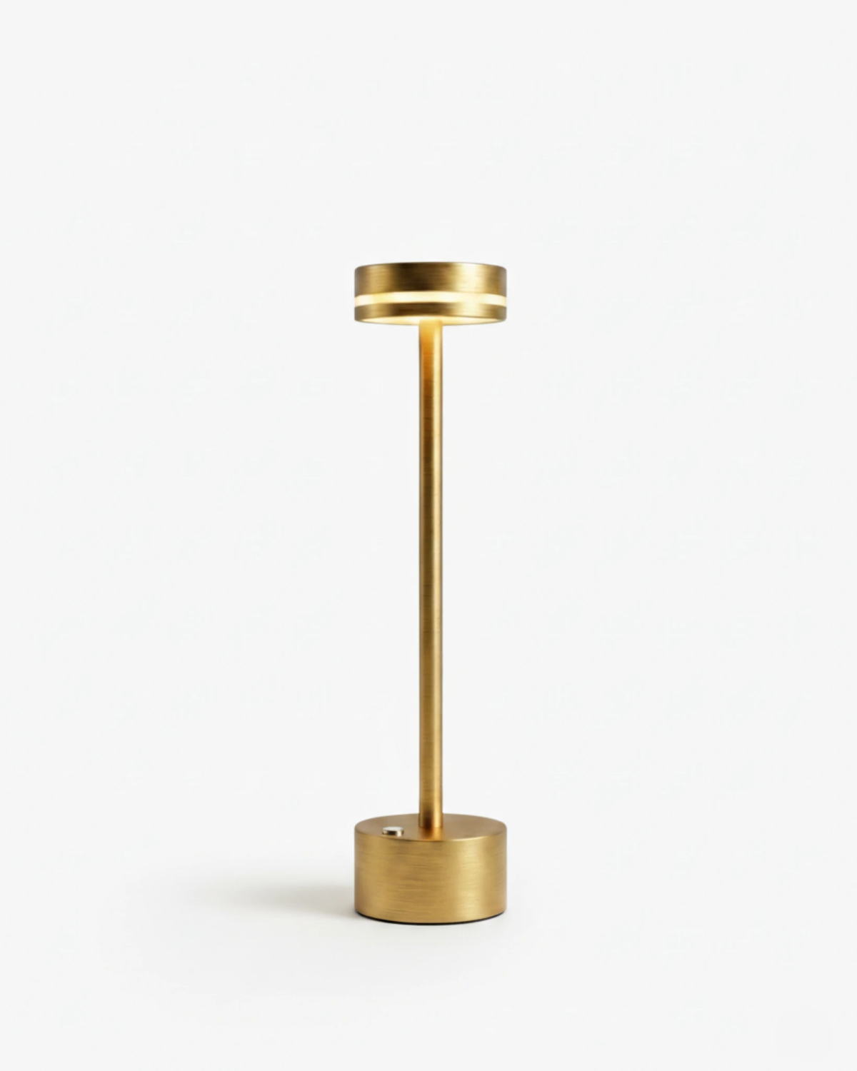 Cordless table lamp NIDO No.02 in Gold, slim brass toned stem with a flat lit ring head and round base