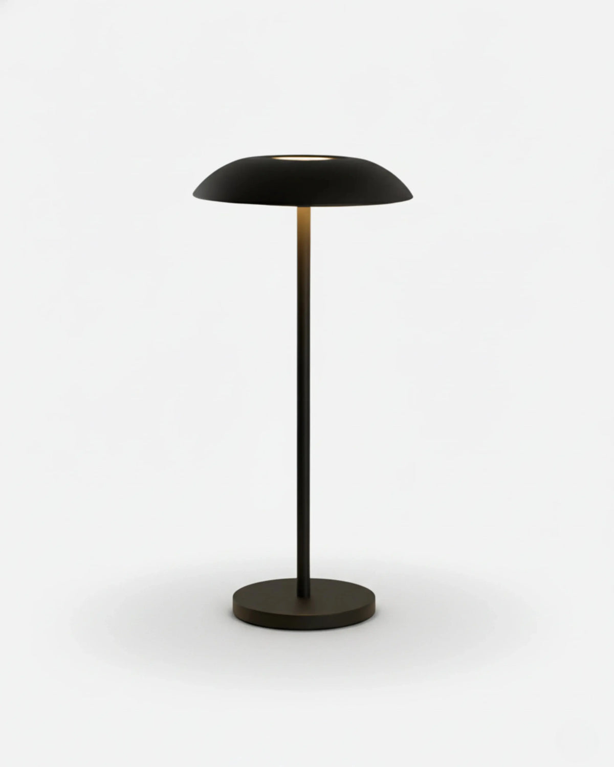 Cordless table lamp PESCARA No.01 in Matte Black, slim stem and dome shade with the light switched on