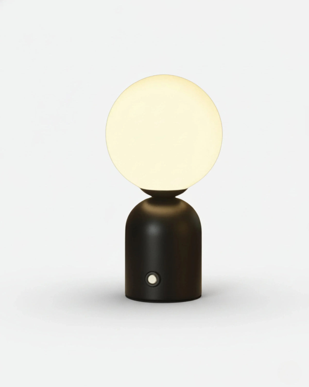 Cordless table lamp VIVA No.01 in Matte Black, glowing opal mini globe on a rounded black base with a button