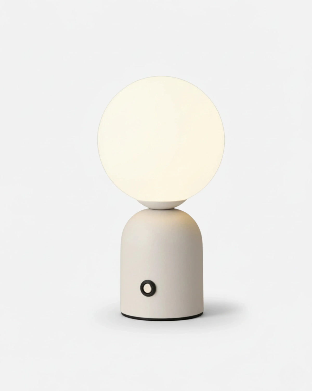 Cordless table lamp VIVA No.01 in Pure White, mini opal globe switched on above a white rounded base