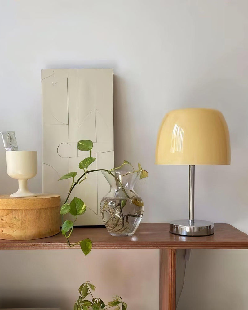 Glass table lamp VENEZIA No.01 with cream shade, unlit, on a wooden sideboard with a potted plant and glass vase