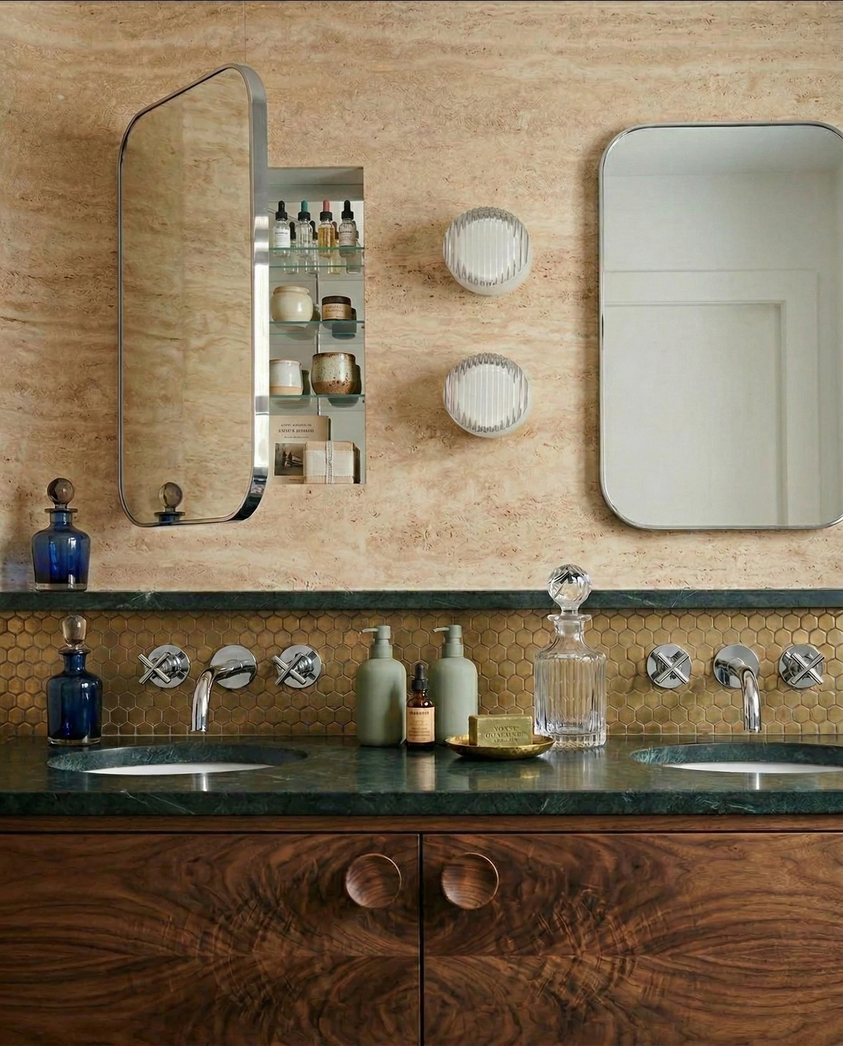 Glass wall sconce HALO No.08, two opal units stacked between mirrors on a travertine bathroom vanity wall
