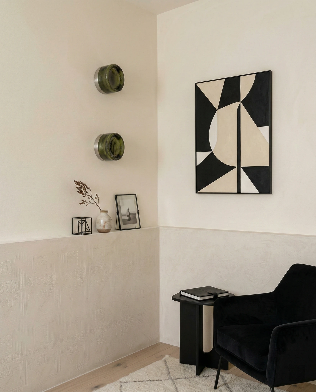 Glass wall sconce HALO No.08, two forest green units stacked on a cream wall near a black armchair