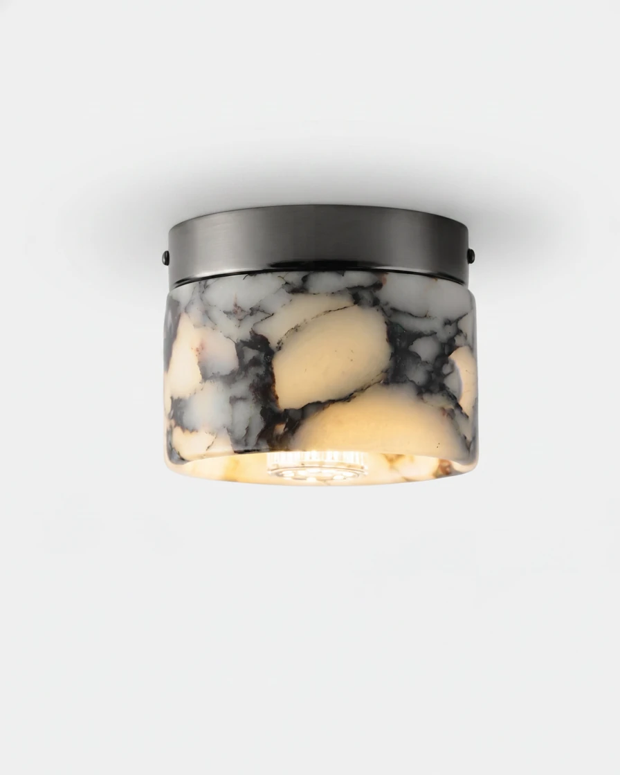 Marble flush mount ceiling light NERA No.06, white marble cylinder with dark veins glowing amber under a black ring
