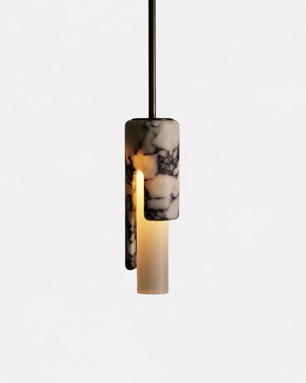 Marble pendant light PALERMO No.01 in Veined Marble, cylinder switched on with the cutaway revealing a warm inner tube