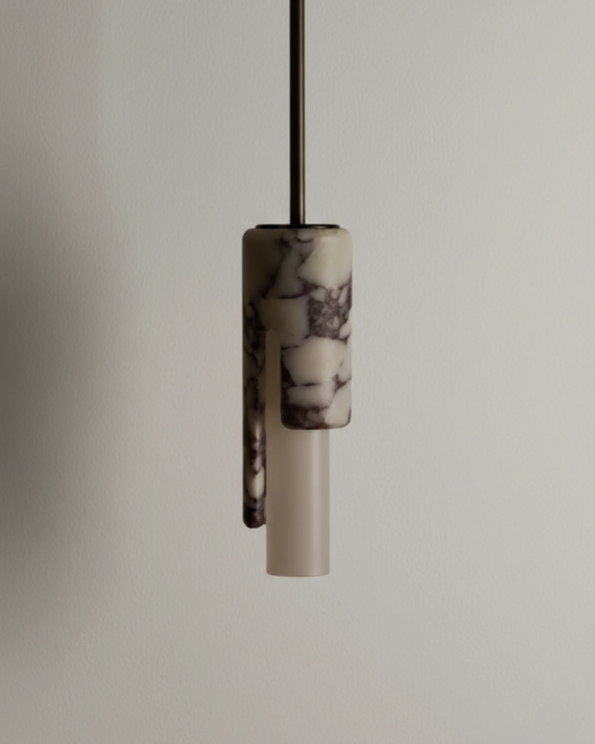 Marble pendant light PALERMO No.01 unlit, white and gray veined marble cylinder with its vertical cutaway on a black rod