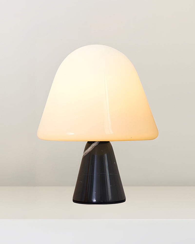 Marble table lamp OLIVA No.04 in volcano black, opal dome switched on above a dark conical marble base