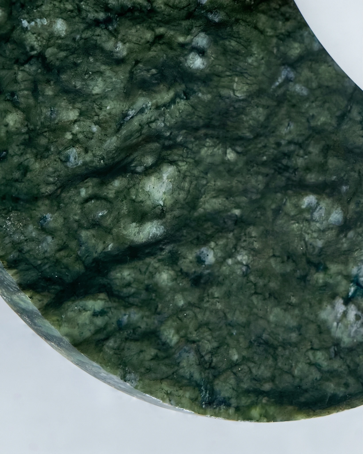 Close-up of the emerald green marble disc texture on the VENA No.01 marble wall sconce