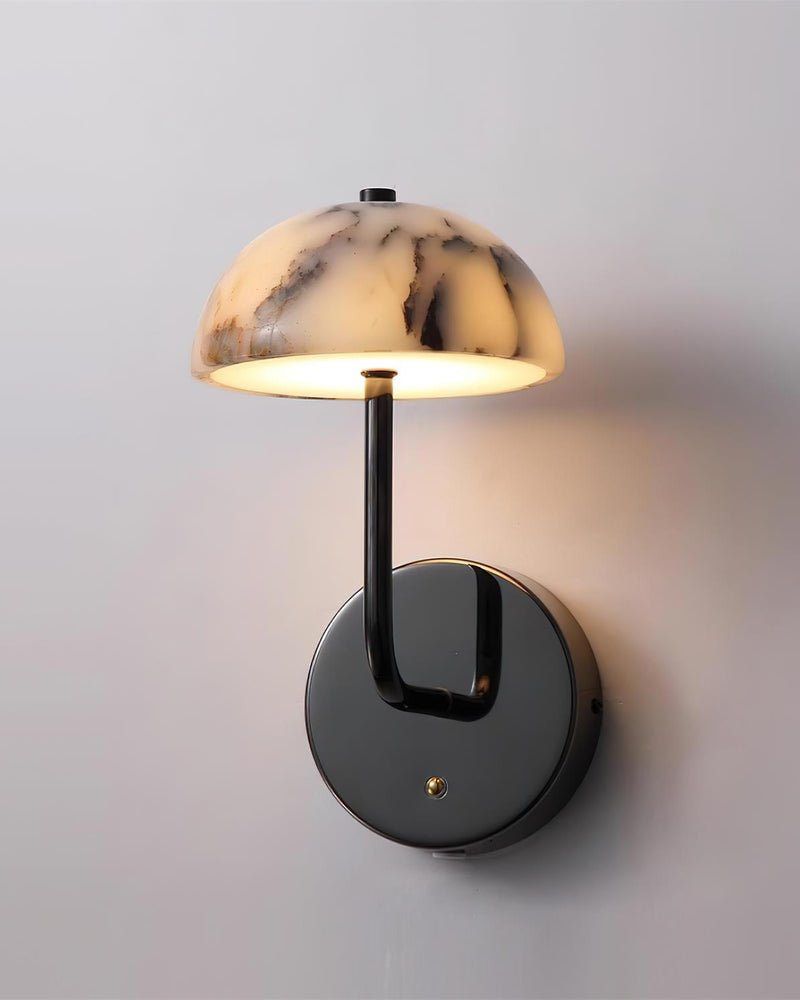 Marble wall sconce NUVOLA No.01 switched on, veined marble dome glowing on a polished gunmetal arm and round backplate
